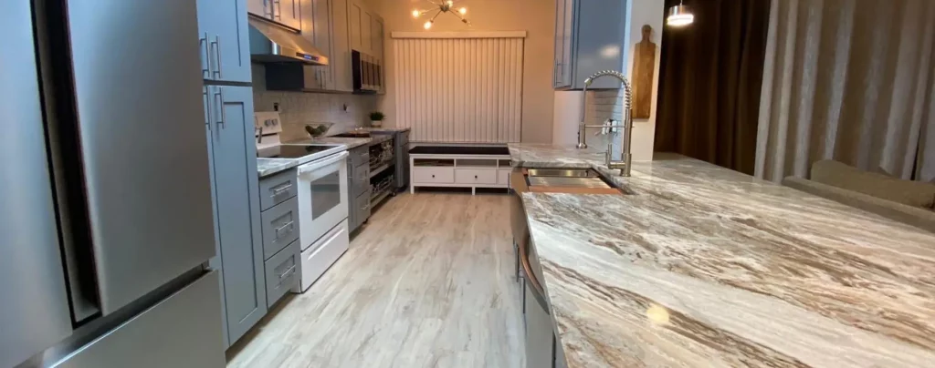 Modern kitchen remodeling with large island and custom stone countertops in Boca Raton