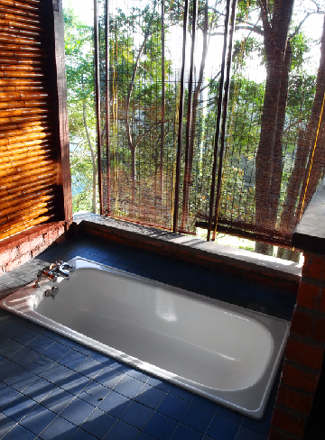 Open concept bathroom remodeling with built-in bathtub and natural views