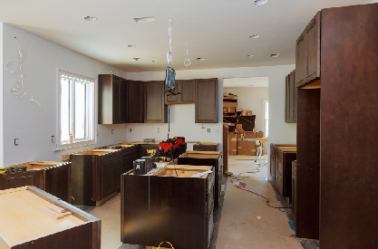 Kitchen remodeling in progress with cabinet installation during home renovation