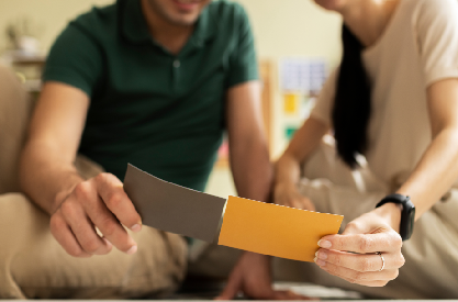 Homeowners reviewing kitchen remodeling color samples during renovation planning consultation