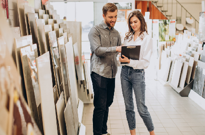 Couple choosing tile samples in a showroom during kitchen and bathroom remodeling consultation