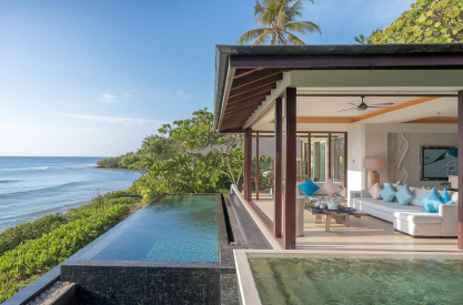Luxury waterfront home with infinity pool, open-air living room, and ocean views