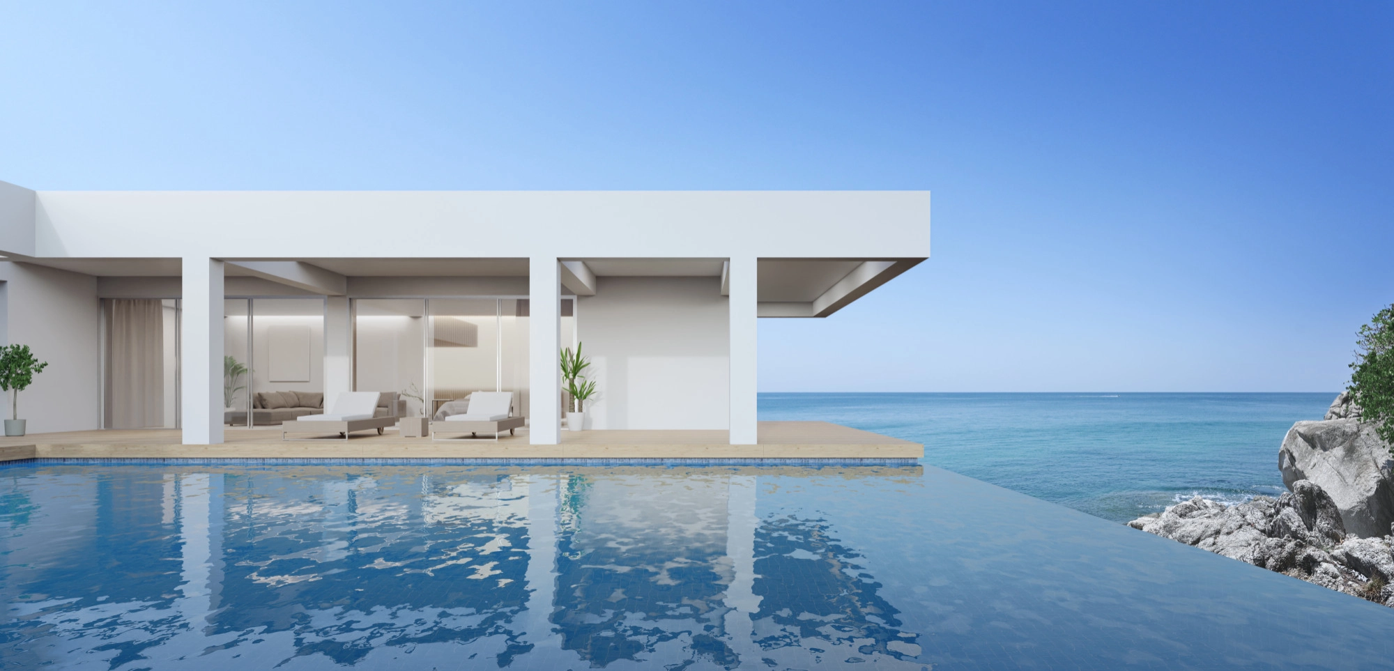 Modern waterfront home with infinity pool, ocean view, lounge area, and coastal outdoor space