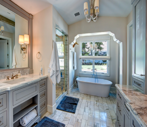 Custom bathroom remodel featuring a freestanding tub, glass shower, and dual vanity