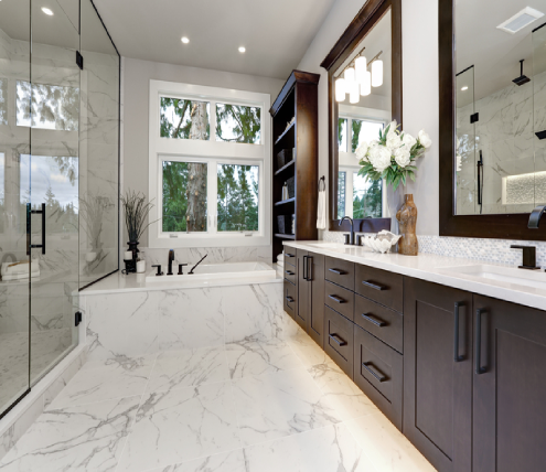 Luxury master bathroom remodel featuring a double vanity, marble finishes, frameless glass shower, and soaking tub.