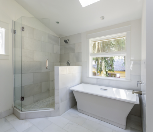 Modern bathroom renovation featuring a walk-in shower and freestanding soaking tub
